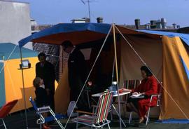 Phyliss Snider, two unknown men and a child in front of a tent