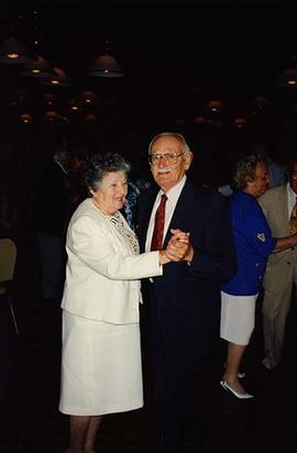 [Unknown man and woman dancing and smiling for the camera at an unknown event]