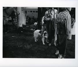 [Two Rodeo Clowns and a Dog]