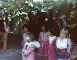 Group of children standing in sukkah