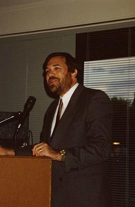 [David Levi speaking at a podium at an unknown event]