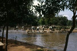 Group of young people in uniform by a river