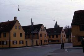 Street with identical orange buildings on either side of the road