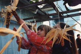 Unidentified girl decorating sukkah