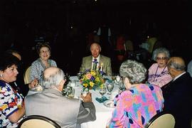 [Unknown people sitting at a table at an unknown event]