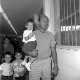 Unidentified man holding child