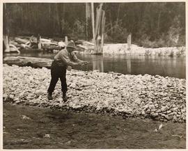 Fly-fisherman on rocky shore