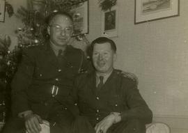 [Dr. Irving Snider and another unknown man wearing army uniforms posing for the camera with a Chr...