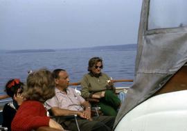 Phyliss Snider and three other unknown people sitting on a boat