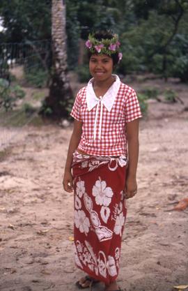 Unidentified girl standing on a beach