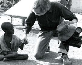 [Bernie Simpson kneeling down and holding an Ethiopian child's hand]