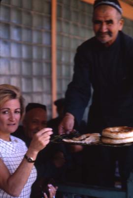 Man serving Phyliss Snider pastry