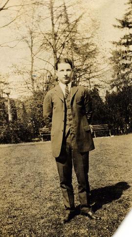 [Irving Snider posing for the camera in what appears to be a park]