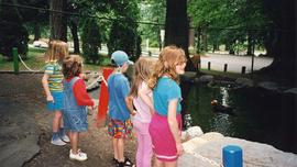 [Children standing in front of a bird pond]