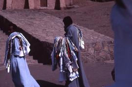 [Men carrying textiles]