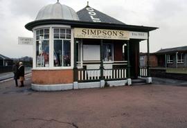 Two people standing in front of Simpson's sports shop