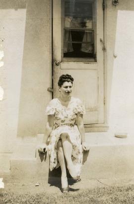 [Unidentified woman sitting on steps]