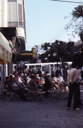 [Outdoor café scene]