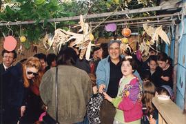 Group of people standing in sukkah