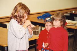 [Unidentified girl blowing a shofar]