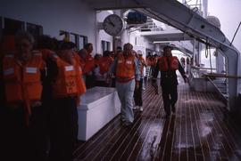 People wearing lifejackets onboard a passenger ship