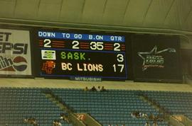 [BC Lions Scoreboard with blue bleachers below]