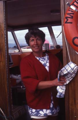 Unknown woman standing in the doorway of a boat