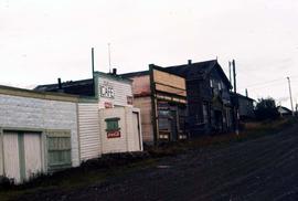 Road in Atlin, B.C including buildings of which one is clearly indicated as a cafe