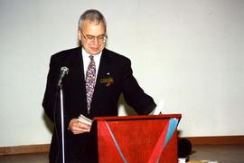 [Bernie Simpson at a red podium for the Opening Collingwood Project]