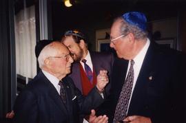 [Dr. Irving Snider speaking with an unknown man and both men are wearing kippahs]