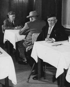 Men sitting at tables at the Jewish Home for the Aged