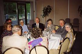 [Unknown people at an unknown event sitting around a table]