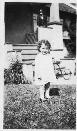 Helen Soskin on front lawn, bicycle