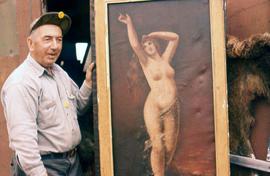 Man standing next to a painting