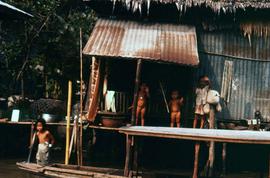 Group of children standing on a platform that is part of a house