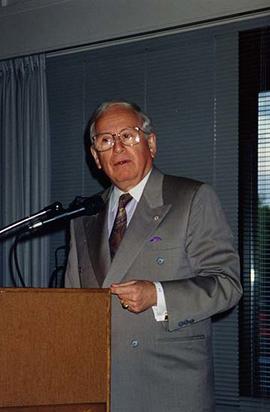 [Joe Segal speaking at a podium at an unknown event]