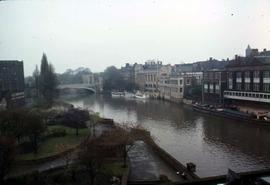 Buildings and a park along a river