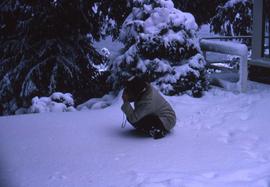 Probably Irving Snider crouching in the snow taking a picture