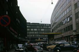 Cars in a street with buildings on either side