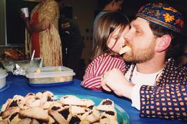 [Unidentified man eating hamantaschen]