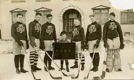 [Hockey team posing for the camera wearing St. Pats sweaters and holding hockey sticks]