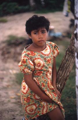 Girl standing next to a tree