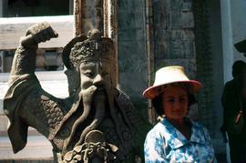 Phyliss Snider standing next to a stone statue