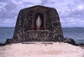 Stone place of worship for Mary, mother of Jesus, located on a sandy beach by the water