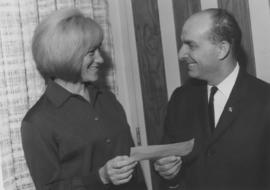 Unidentified man and woman giving a cheque to the JCCGV