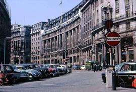 Curved street with many parked cars