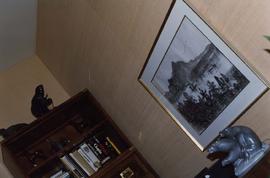 [Angled shot of a bookcase, painting and sandstone sculpture]