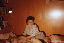 Phyliss Snider sitting on a bed with two of the Snider's dogs