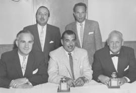 Group of men with two curling trophies