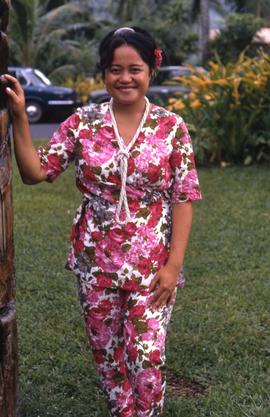 Woman dressed in a pink flowery shirt and pants